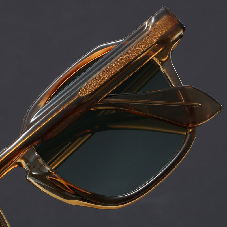 Brown sunglasses with reflective surface on a dark background