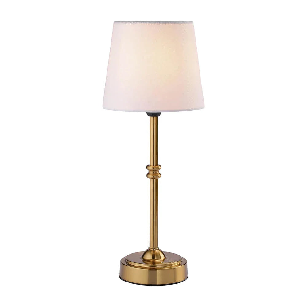 Table lamp with brass base and white shade on a white background