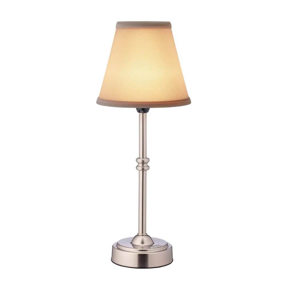Table lamp with beige shade and metallic base on a white background