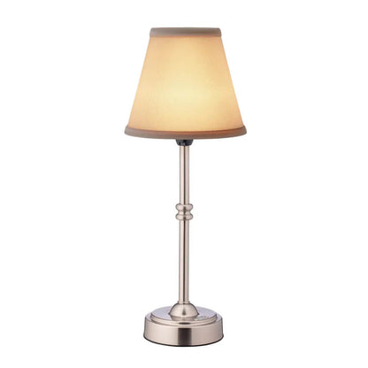 Table lamp with beige shade and metallic base on a white background