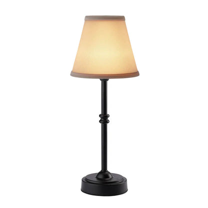 Table lamp with a beige shade and black base on a white background