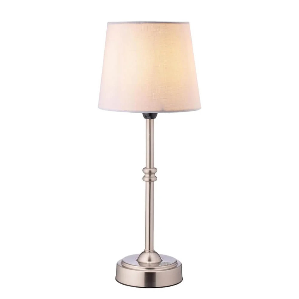 Table lamp with a beige shade and metallic base on a white background