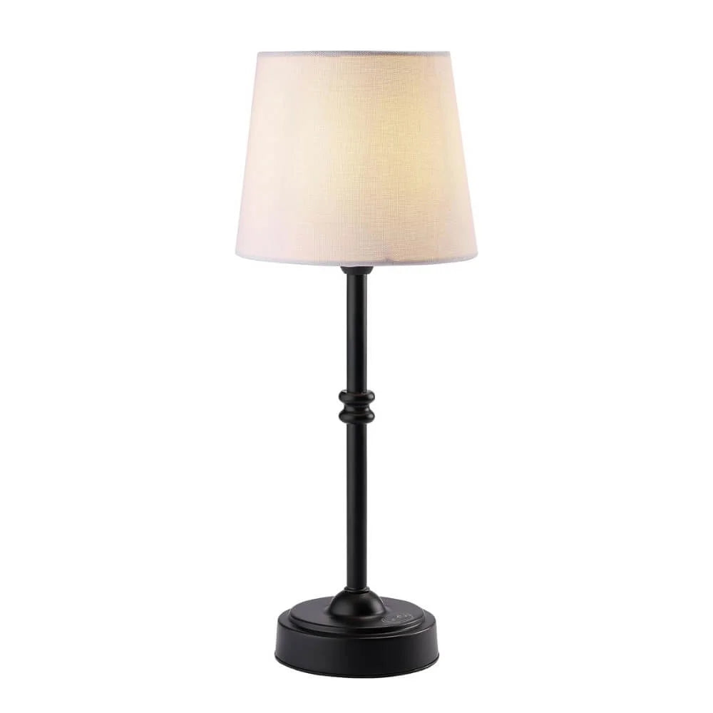 Table lamp with a black base and beige shade on a white background