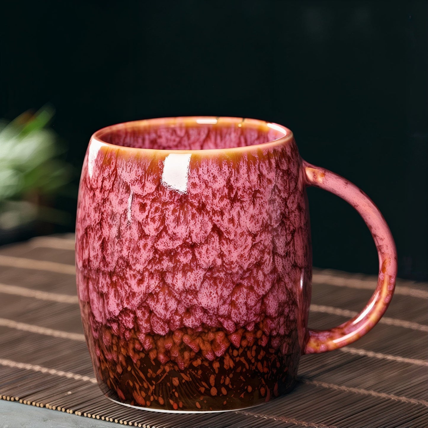 Pink and brown ceramic mug on a woven mat with a blurred background