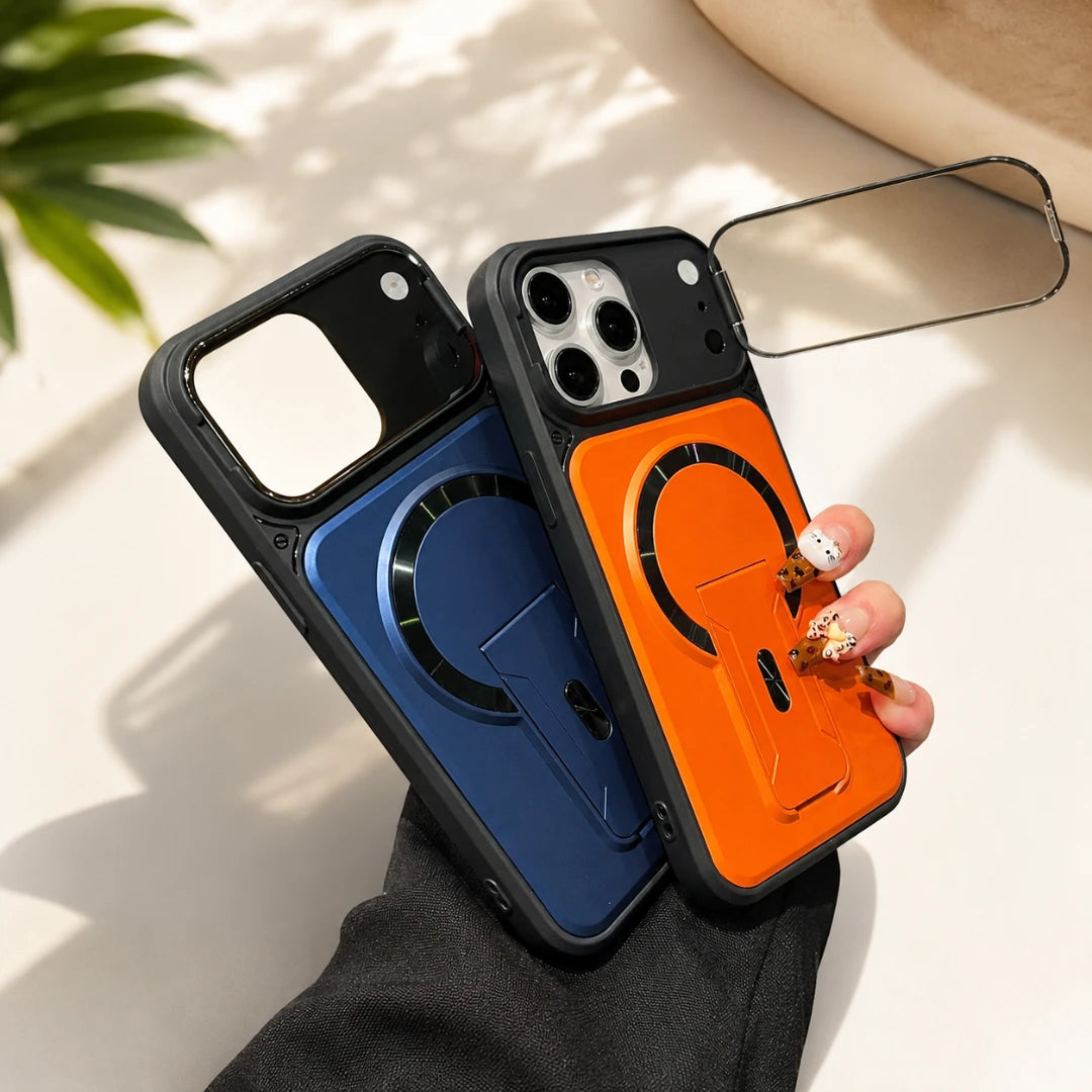 Josh & Tate - RingArmor™ MagSafe iPhone Case - Two MagSafe-compatible phone cases held in a hand, one in metallic blue and one in metallic orange, both with black protective borders and a transparent magnetic ring, set against a bright, sunlit neutral background.