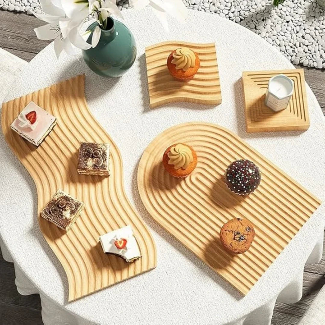 Josh & Tate - Ripple Wave Wooden Serving Tray - Wooden serving trays with assorted pastries on a white tablecloth.