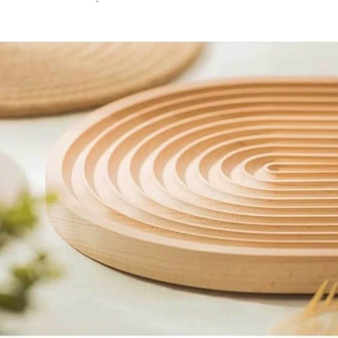 Josh & Tate - Ripple Wave Wooden Serving Tray - Close-up of a woven wooden coaster on a light surface.