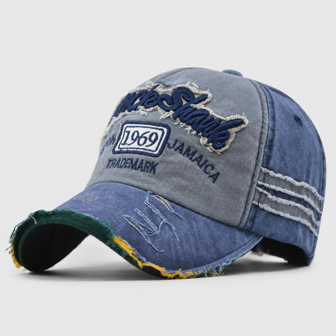 Josh & Tate - RockShank™ 1969 Baseball Cap - A distressed denim baseball cap with 'Sharks' embroidered on the front, featuring a faded blue wash, frayed edges, and a white '1969' patch.