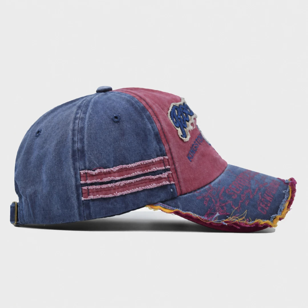 Josh & Tate - RockShank™ 1969 Baseball Cap - A distressed baseball cap with a washed blue denim front and a faded red brim, featuring embroidered patches and frayed details.