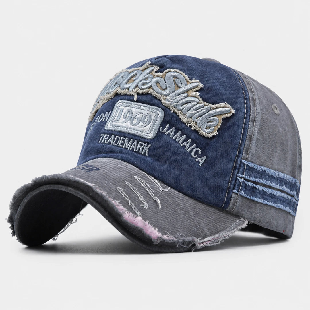 Josh & Tate - RockShank™ 1969 Baseball Cap - A distressed baseball cap featuring a dark blue denim front panel with embroidered 'Little Shake' and 'Jamaica' text, paired with faded gray washed denim panels on the sides and brim.