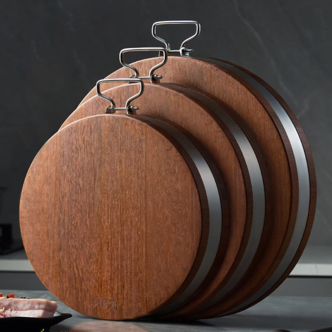 Set of wooden cutting boards with metal clips on a dark background