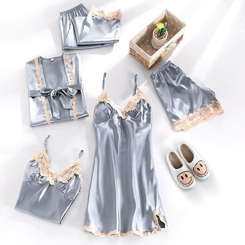 Silver satin pajama set with lace details on a white background