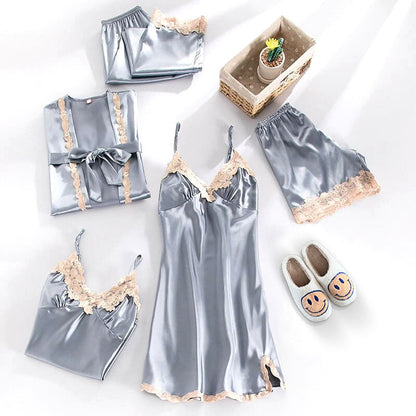 Silver satin pajama set with lace details on a white background