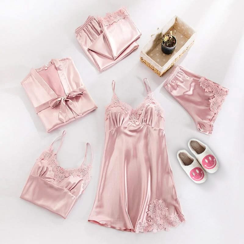 Pink satin nightgown set with matching items on a white background