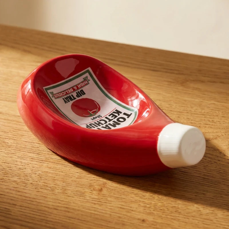 Josh &n Tate - SaucePad™ Condiment Dip Tray - Red ketchup bottle-shaped dish on a wooden surface