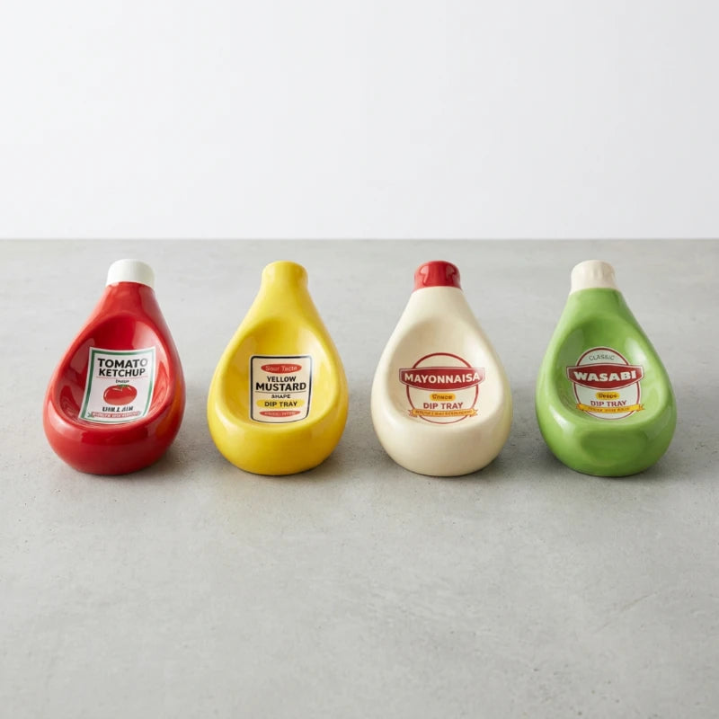 Josh & Tate - SaucePad™ Condiment Dip Tray - Four condiment bottles labeled Ketchup, Mustard, Mayonnaise, and Wasabi on a light gray surface.