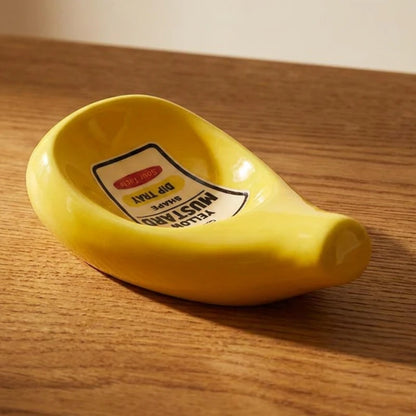 Josh & Tate - SaucePad™ Condiment Dip Tray - Yellow mustard container with a label on a wooden surface