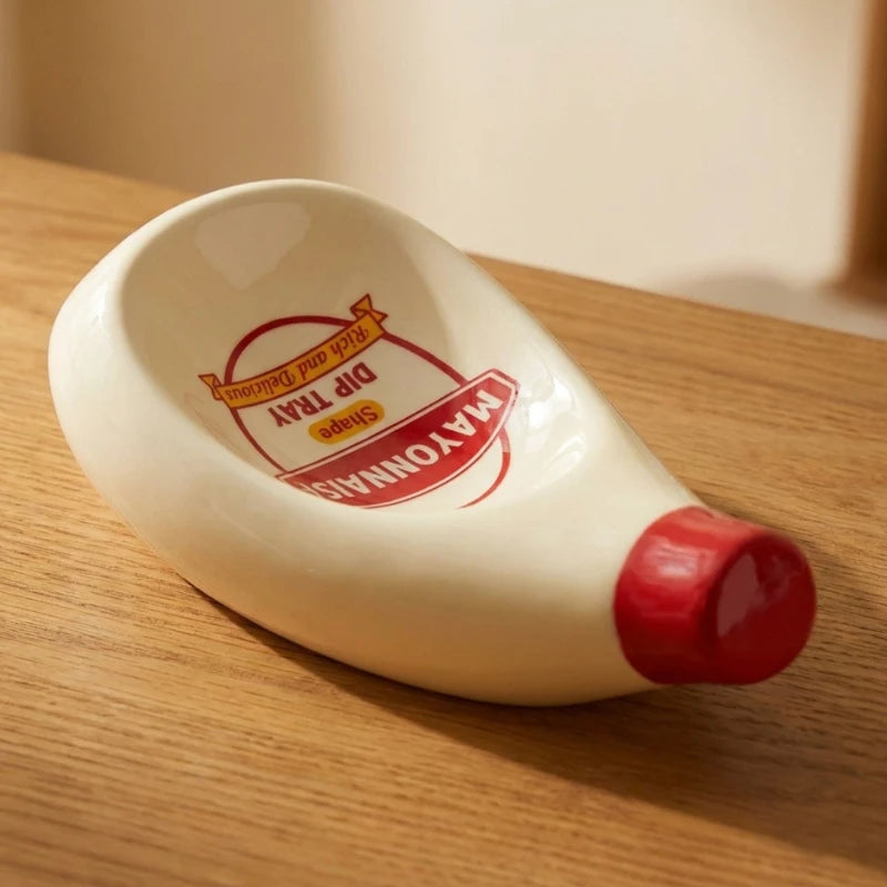 Josh & Tate - SaucePad™ Condiment Dip Tray - White ceramic mayonnaise bottle with red cap on a wooden surface