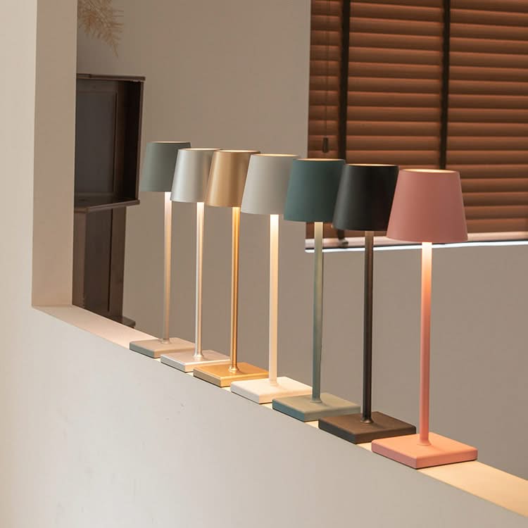 Row of colorful table lamps on a neutral background