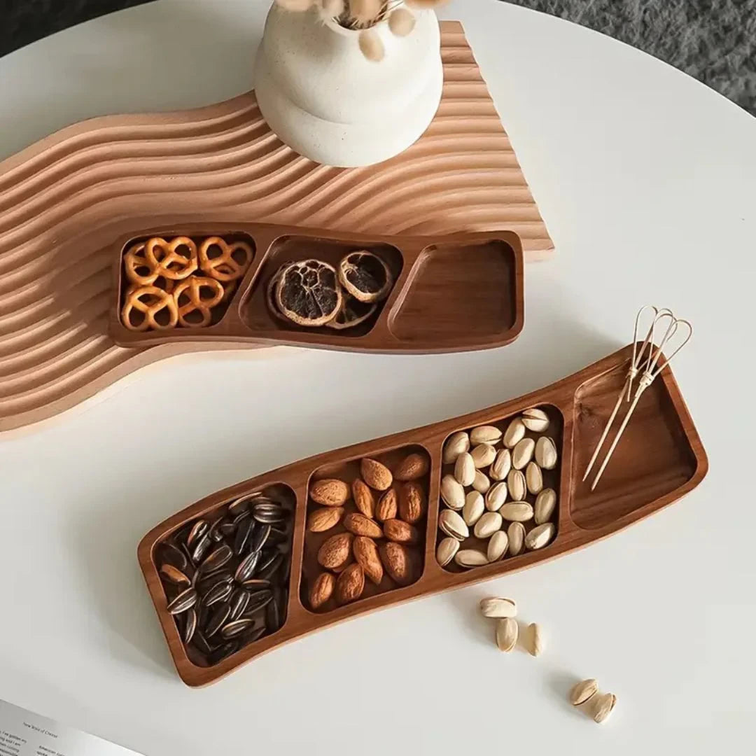 Josh & Tate - Sectioned Wooden Serving Tray - Wooden snack tray with compartments filled with various nuts on a white surface.
