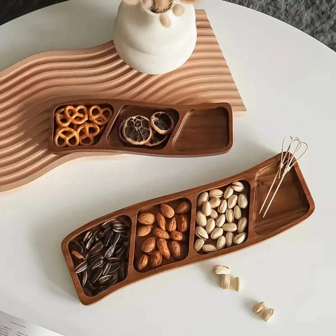 Josh & Tate - Sectioned Wooden Serving Tray - Wooden snack tray with compartments filled with various nuts on a white surface.