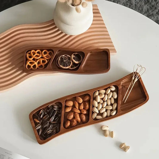 Josh & Tate - Sectioned Wooden Serving Tray - Wooden snack tray with compartments filled with various nuts on a white surface.