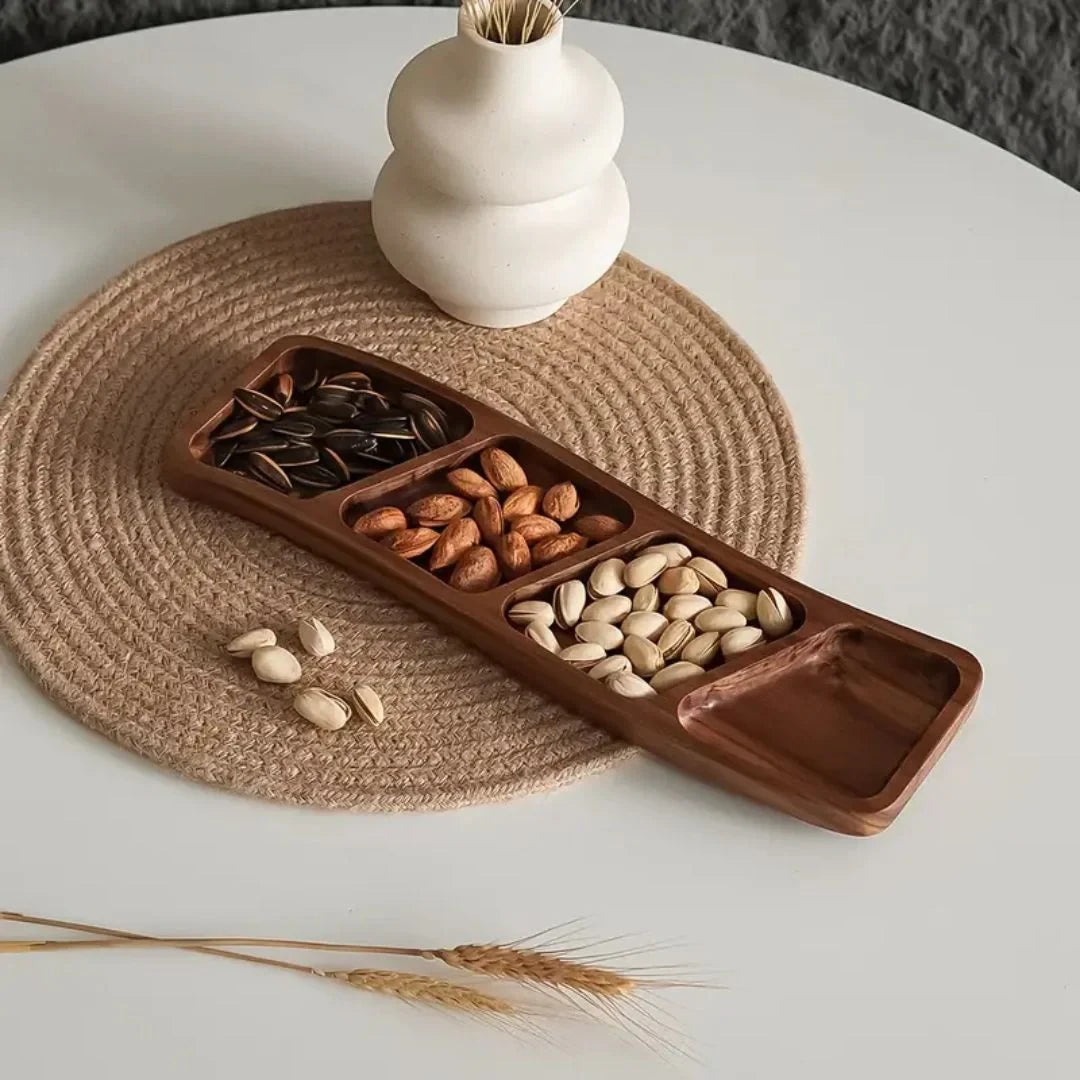 Josh & Tate - Sectioned Wooden Serving Tray - Wooden snack tray with compartments filled with nuts on a white table with a woven placemat.
