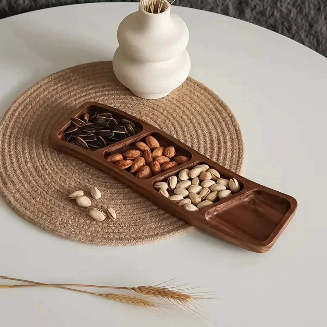 Josh & Tate - Sectioned Wooden Serving Tray - Wooden snack tray with compartments filled with nuts on a white table with a woven placemat.