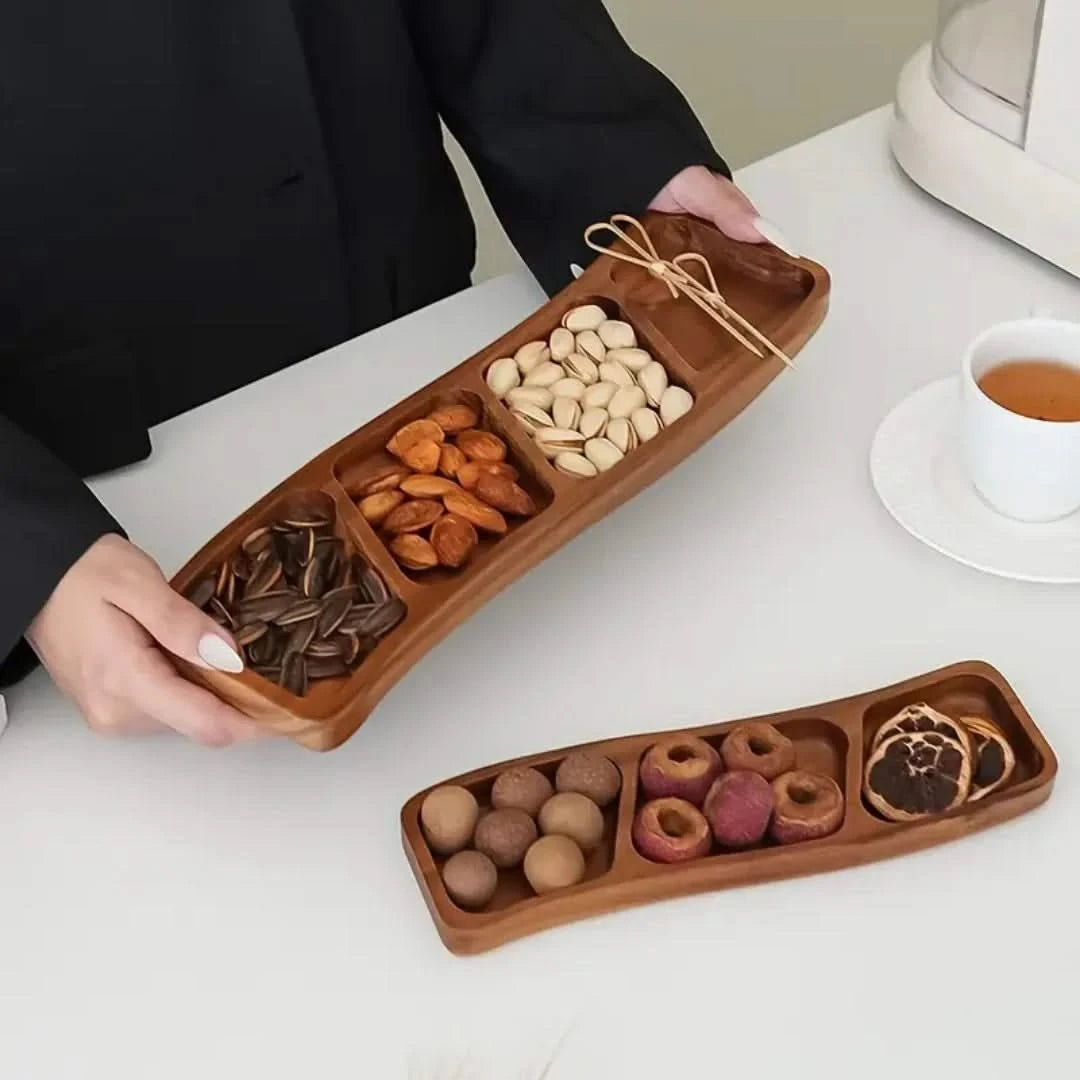 Josh & Tate - Sectioned Wooden Serving Tray - Wooden snack tray with compartments filled with various nuts and dried fruits on a white surface.