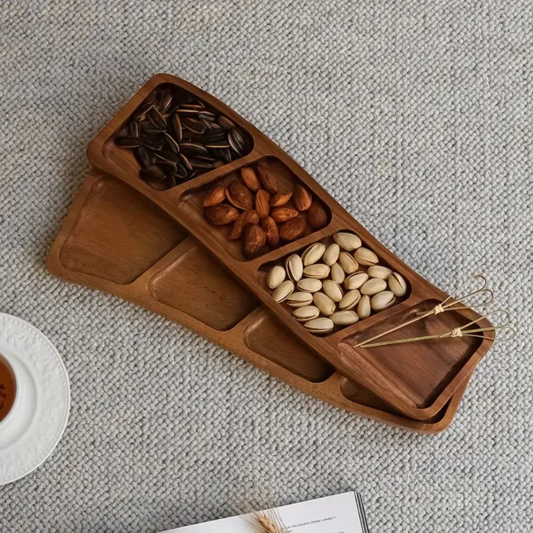 Josh & Tate - Sectioned Wooden Serving Tray - Wooden snack tray with compartments filled with nuts on a textured surface