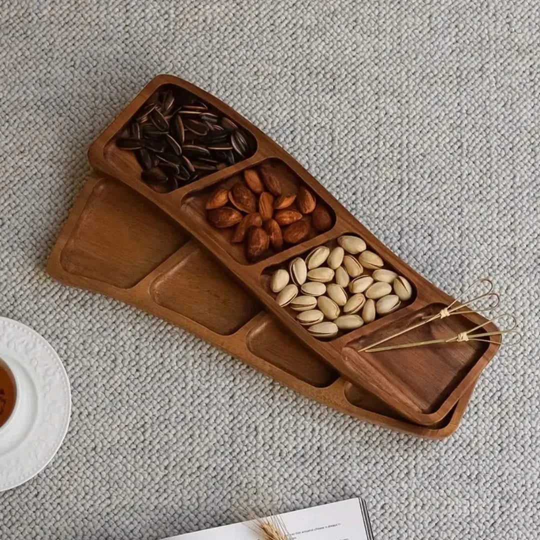 Josh & Tate - Sectioned Wooden Serving Tray - Wooden snack tray with compartments filled with nuts on a textured surface
