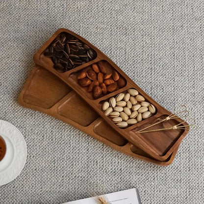 Josh & Tate - Sectioned Wooden Serving Tray - Wooden snack tray with compartments filled with nuts on a textured surface