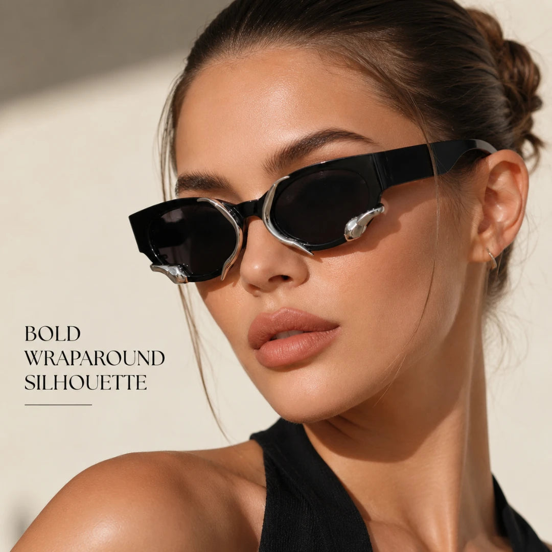 Josh & Tate - SerpentEdge™ Statement Sunglasses - A close-up lifestyle shot of a model wearing bold wraparound sunglasses with a black frame and silver metal accents. The text 'BOLD WRAPAROUND SILHOUETTE' is visible on the left side against a warm beige background.