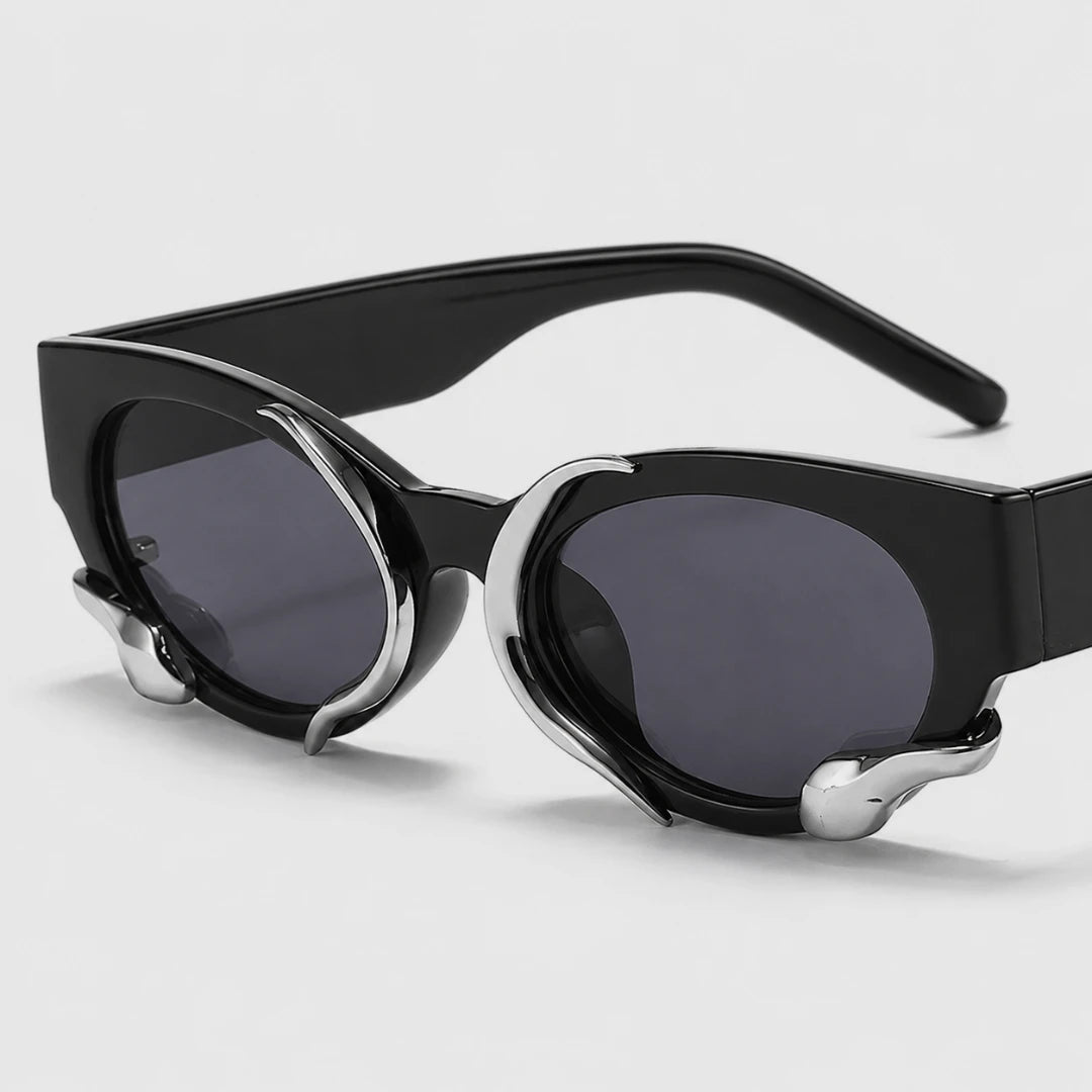 Josh & Tate - SerpentEdge™ Statement Sunglasses - Black cat-eye sunglasses with dark gray lenses and silver metal accents on the front, shown on a light gray background.