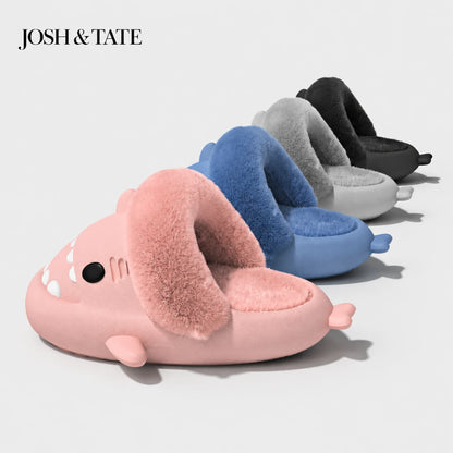 Josh & Tate - SharkStep™ Plush Slip-On Slipper - Set of shark-shaped slippers in pink, blue, gray, and black by Josh & Tate on a light gray background.