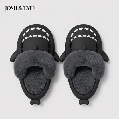Josh & Tate - SharkStep™ Plush Slip-On Slipper - Black shark-shaped slippers with gray fur interior on a light gray background, featuring the brand 'Josh & Tate'.