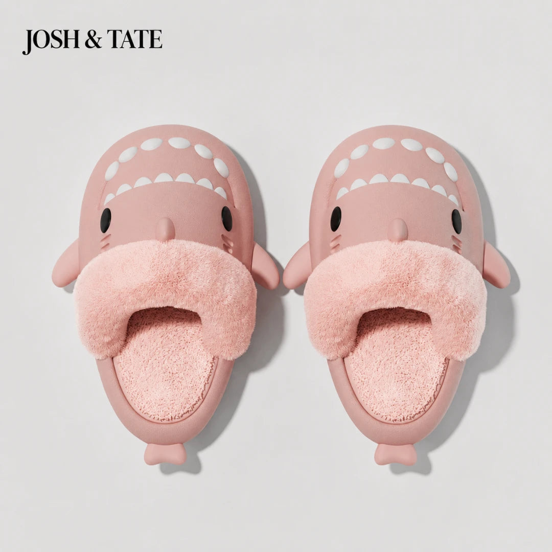 Josh & Tate - SharkStep™ Plush Slip-On Slipper - Pink shark-shaped slippers with a fluffy interior on a light gray background, branded 'JOSH & TATE'.