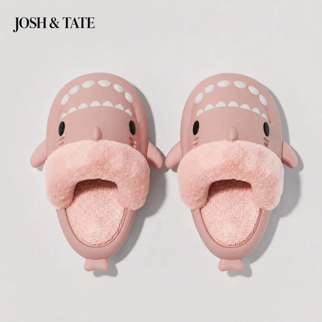 Josh & Tate - SharkStep™ Plush Slip-On Slipper - Pink shark-shaped slippers with a fluffy interior on a light gray background, branded 'JOSH & TATE'.