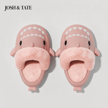 Josh & Tate - SharkStep™ Plush Slip-On Slipper - Pink shark-shaped slippers with a fluffy interior on a light gray background, branded 'JOSH & TATE'.