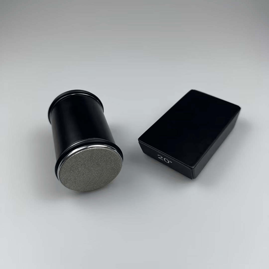 Black cylindrical and rectangular objects on a gray background