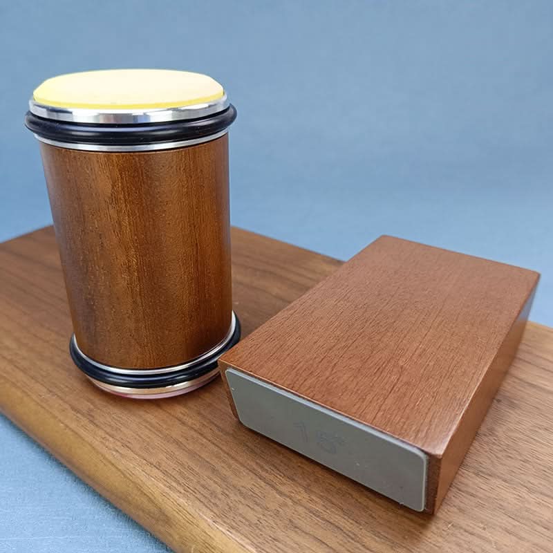 Wooden container with a yellow top and a rectangular wooden block on a light blue background