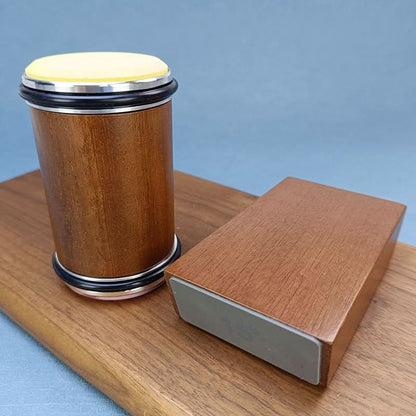Wooden container with a yellow top and a rectangular wooden block on a light blue background