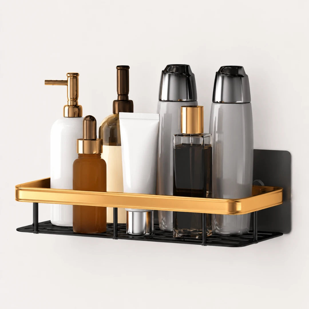 Josh & Tate - ShelfLoft™ Adhesive Shower Shelf - Gold and black wall-mounted bathroom organizer tray holding assorted toiletry bottles and containers against a plain light background.