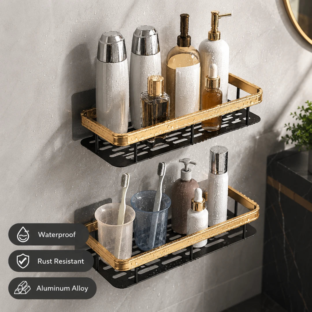 Josh & Tate - ShelfLoft™ Adhesive Shower Shelf - Two black and gold aluminum wall-mounted bathroom shelves holding toiletry bottles, cups, and toothbrushes, shown on a light gray wall with feature callouts in the lower left.