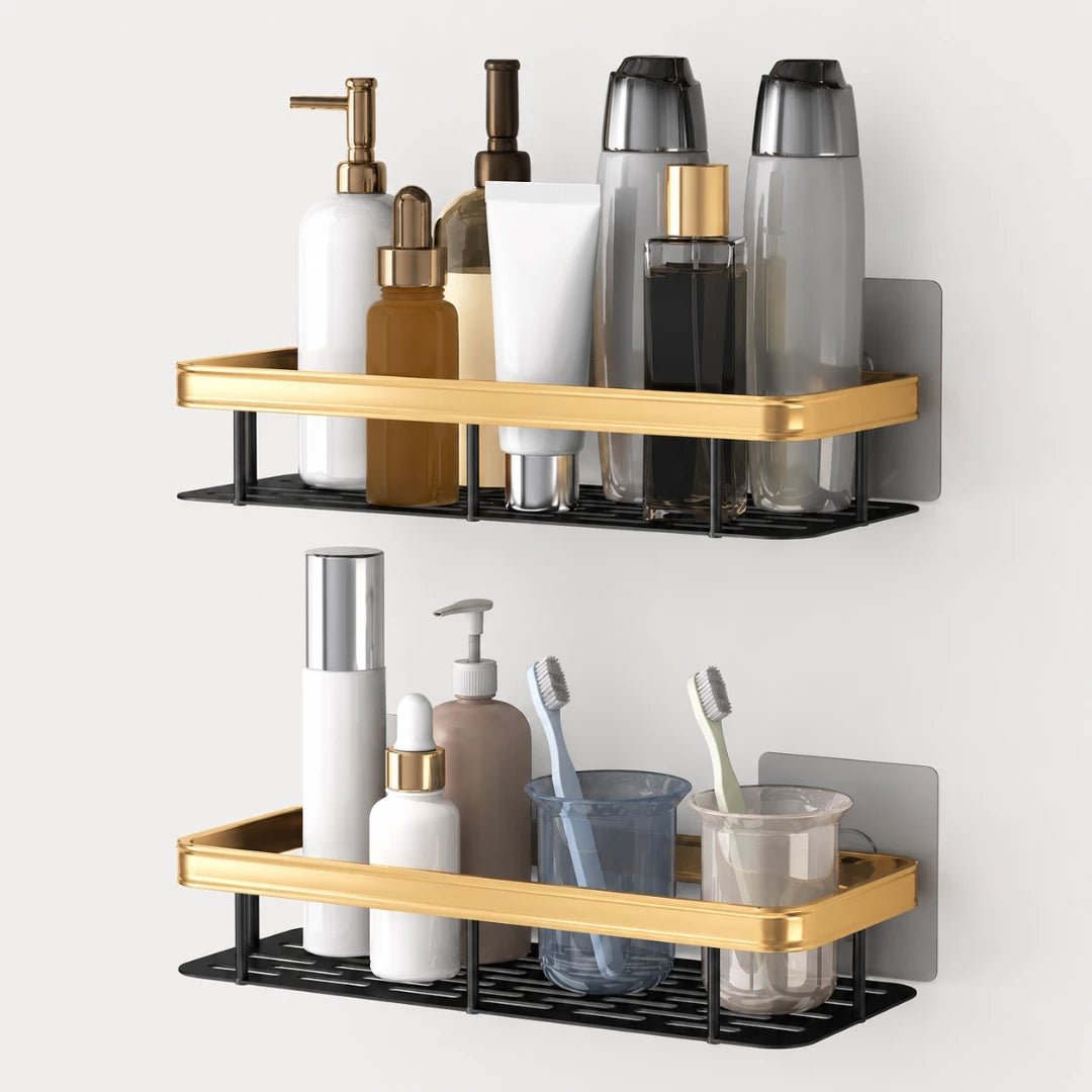 Josh & Tate - ShelfLoft™ Adhesive Shower Shelf - Two wall-mounted bathroom shelves with gold-tone trim and black wire racks, shown holding toiletries and toothbrushes against a light gray wall.