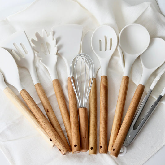 Set of kitchen utensils with wooden handles on a white background