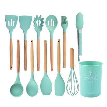 Set of turquoise silicone kitchen utensils with wooden handles on a white background
