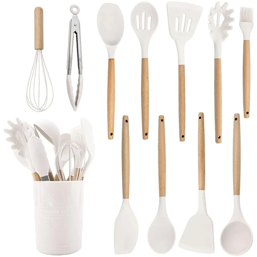 Set of kitchen utensils with wooden handles in a white container on a white background