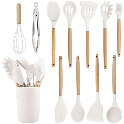 Set of kitchen utensils with wooden handles in a white container on a white background