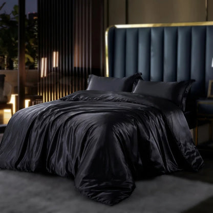 Dark gray bedding on a bed with a modern headboard in a dimly lit room.